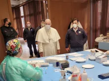 Pope Francis greets medical workers administering the vaccine against COVID-19 April 2, 2021.